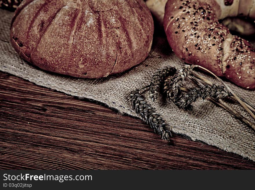 Composition of fresh bread on wooden background