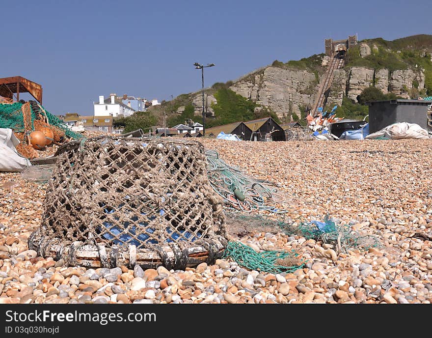 An old crab pot sitting on a pebbled beach. An old crab pot sitting on a pebbled beach