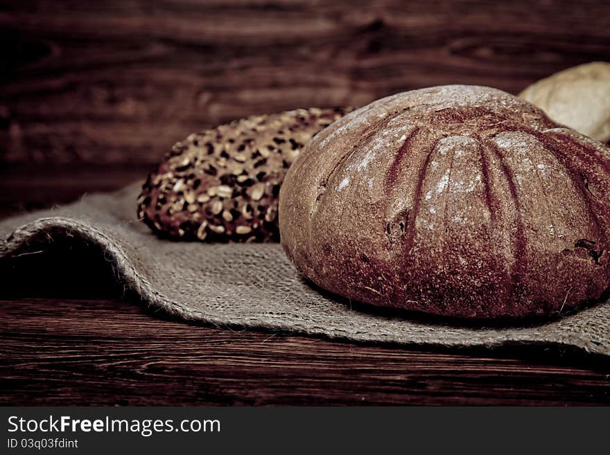 Composition of fresh bread on wooden background