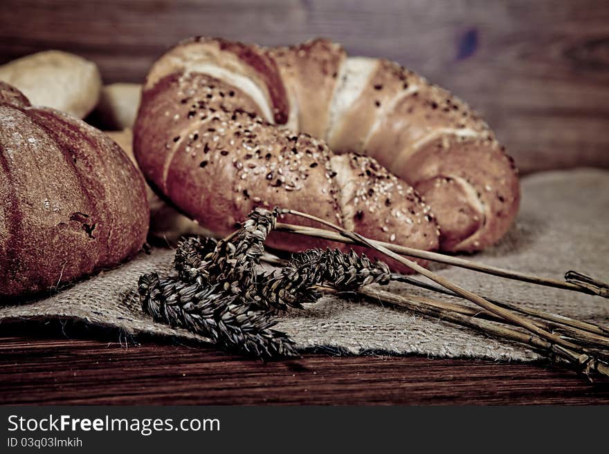 Composition of fresh bread on wooden background