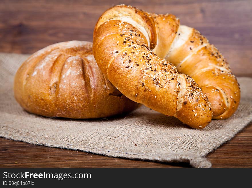 Composition of fresh bread on wooden background