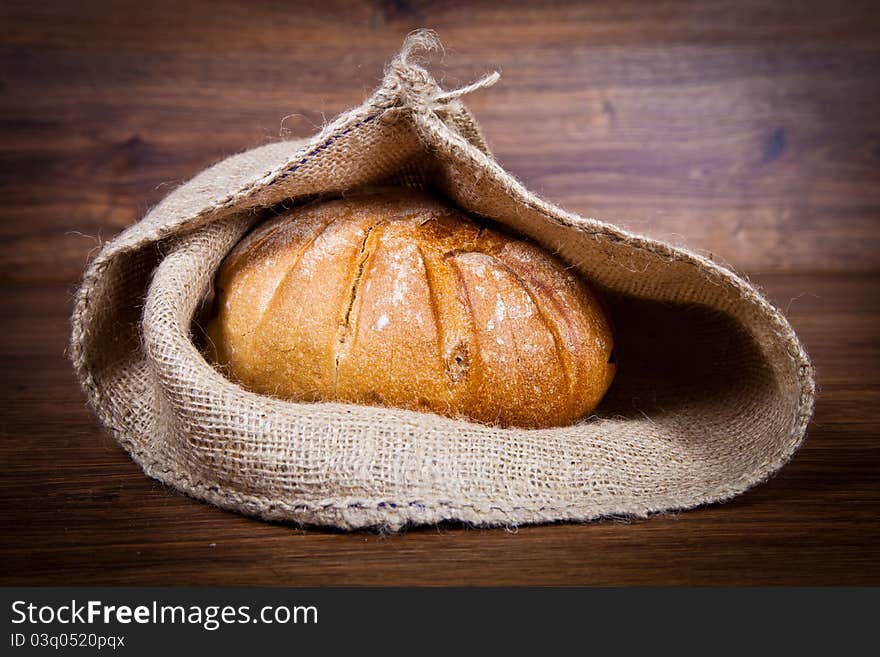 Composition of fresh bread on wooden background