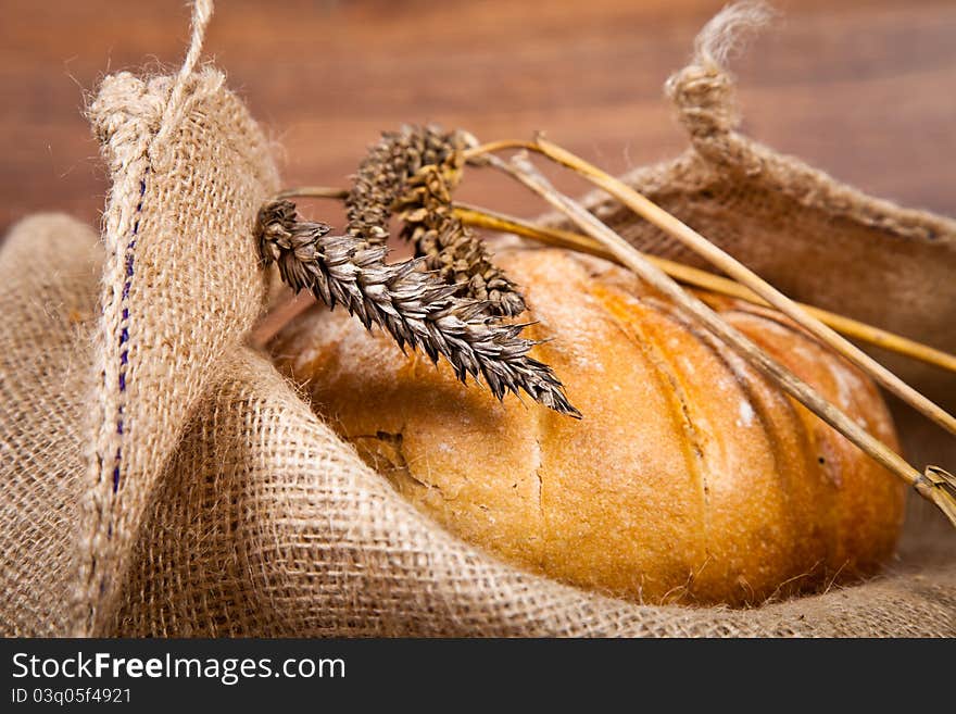 Composition of fresh bread on wooden background