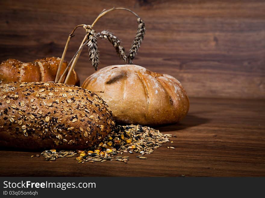 Composition of fresh bread on wooden background