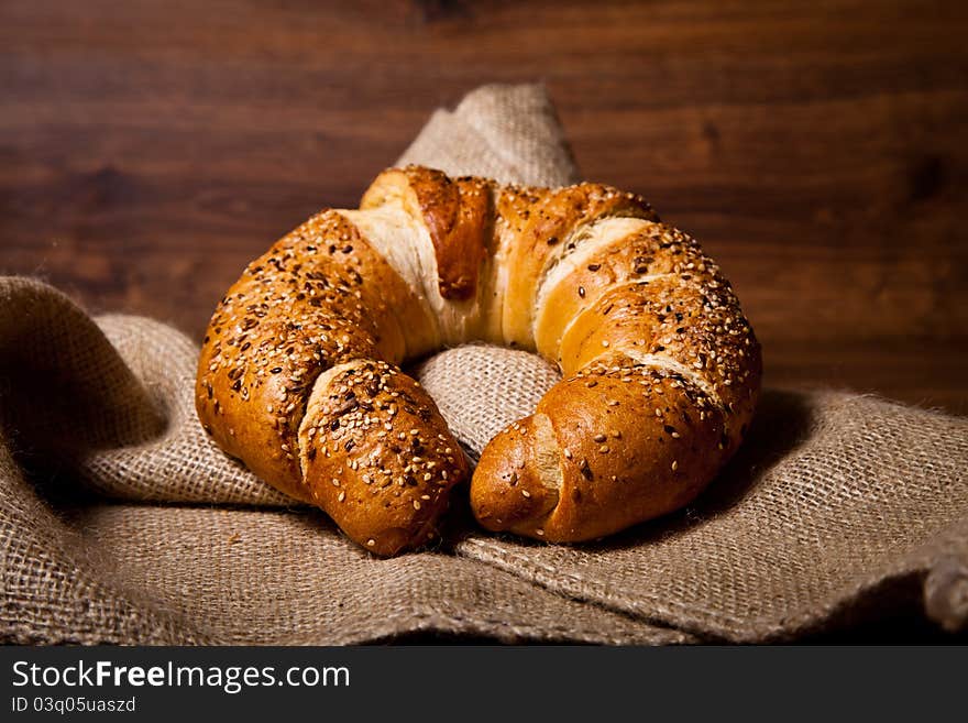 Composition of fresh bread on wooden background