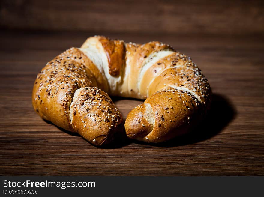 Composition of fresh bread on wooden background