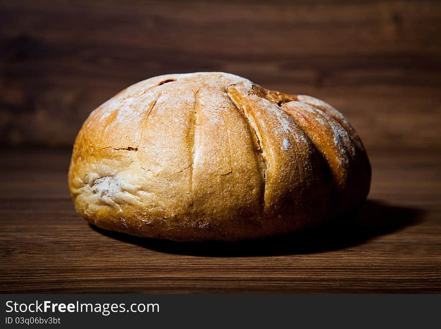 Composition of fresh bread on wooden background