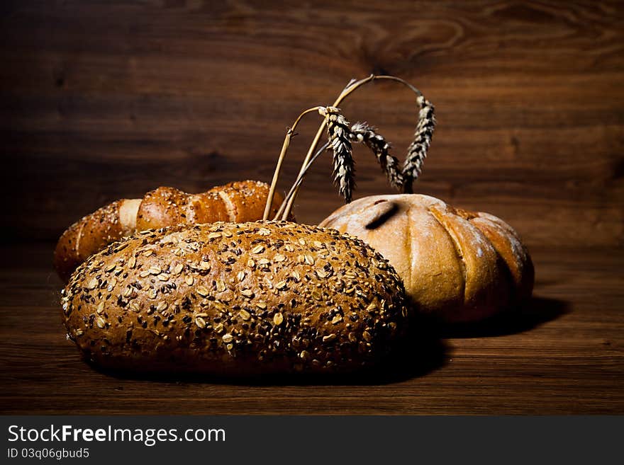 Composition of fresh bread on wooden background