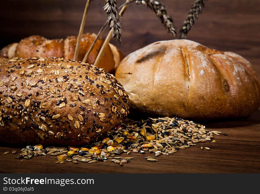 Composition of fresh bread on wooden background