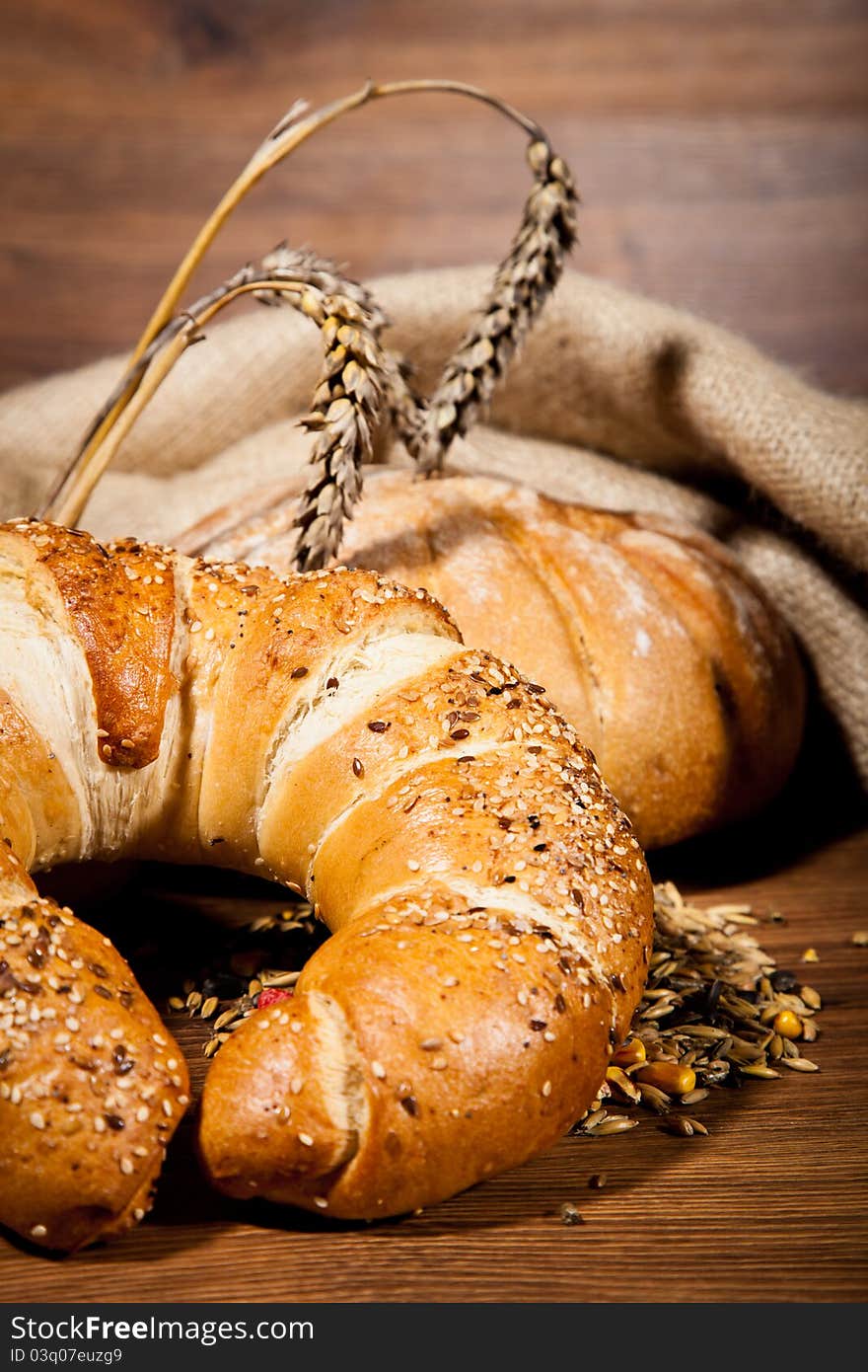 Composition of fresh bread on wooden background