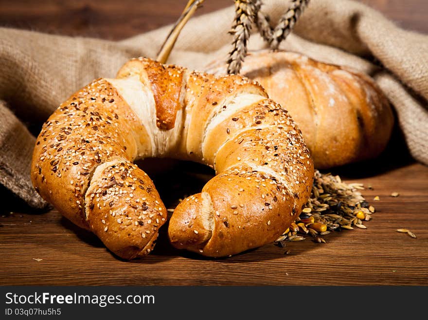 Composition of fresh bread on wooden background