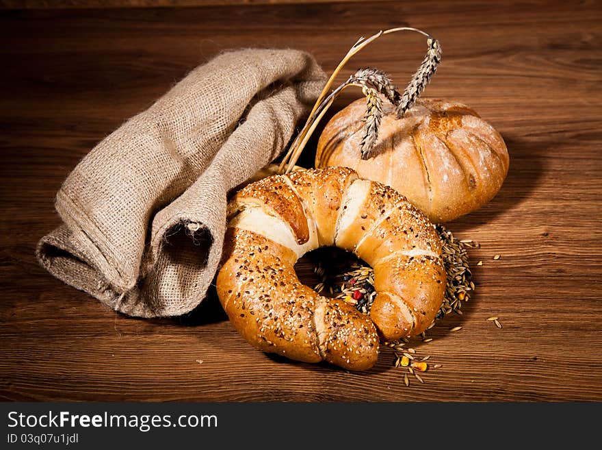 Composition of fresh bread on wooden background