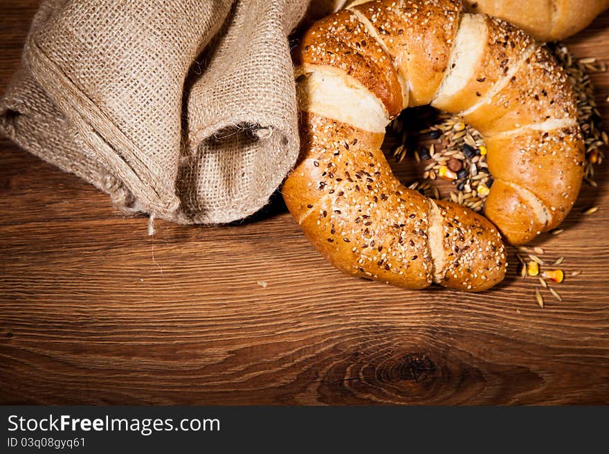 Composition of fresh bread on wooden background