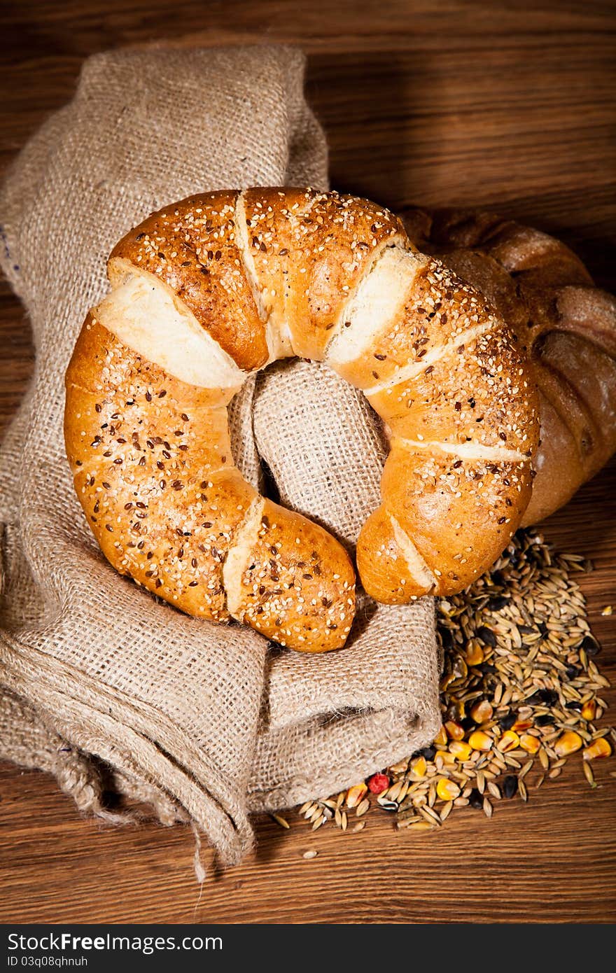 Composition of fresh bread on wooden background