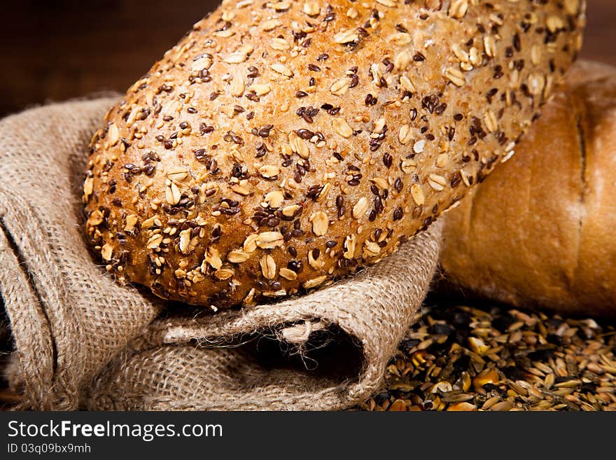 Composition of fresh bread on wooden background