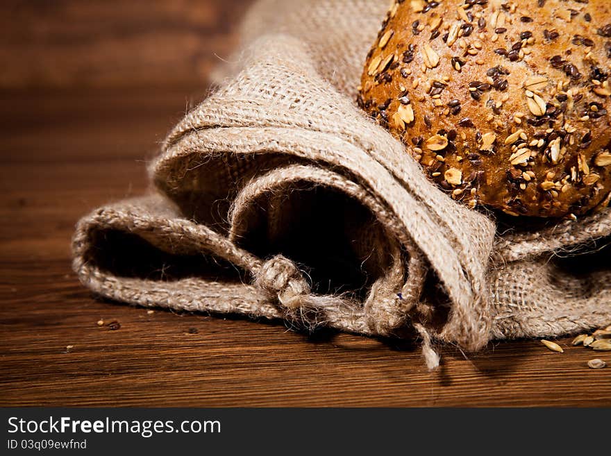 Composition of fresh bread on wooden background