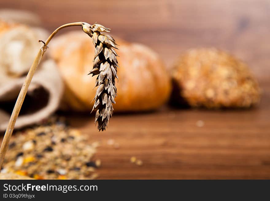 Composition of fresh bread on wooden background