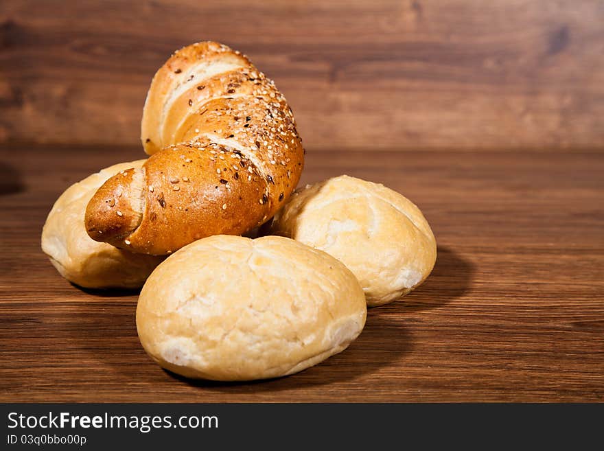 Composition of fresh bread on wooden background