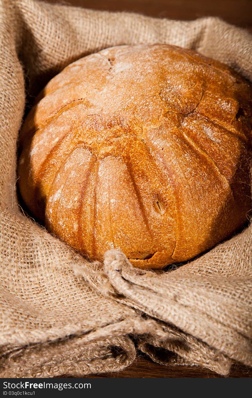 Composition of fresh bread on wooden background