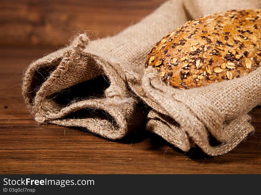 Composition of fresh bread on wooden background