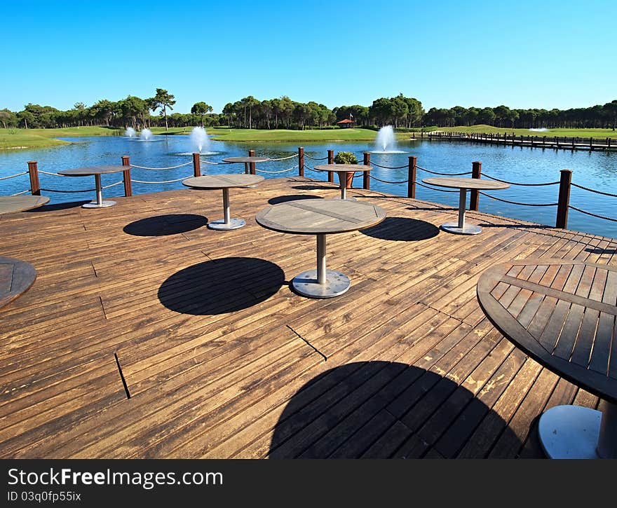 Cafe on the artificial pond with fountain.