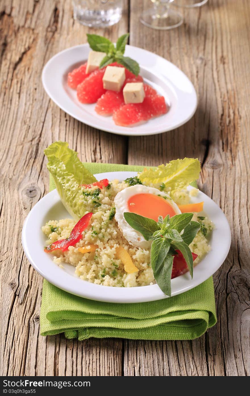 Couscous salad and fried egg, red grapefruit and tofu. Couscous salad and fried egg, red grapefruit and tofu