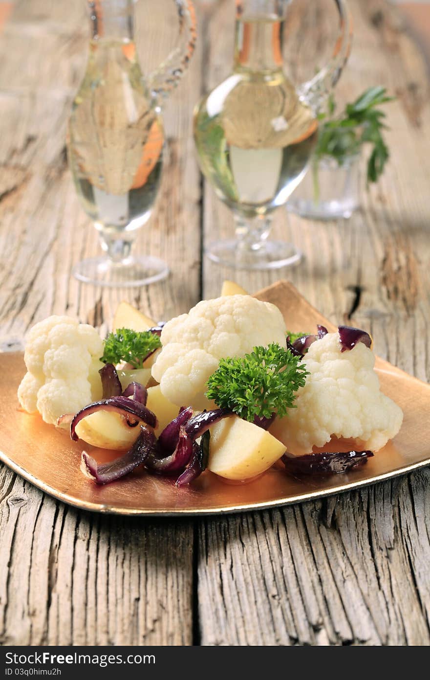 Cauliflower and potatoes garnished with Spanish onion. Cauliflower and potatoes garnished with Spanish onion