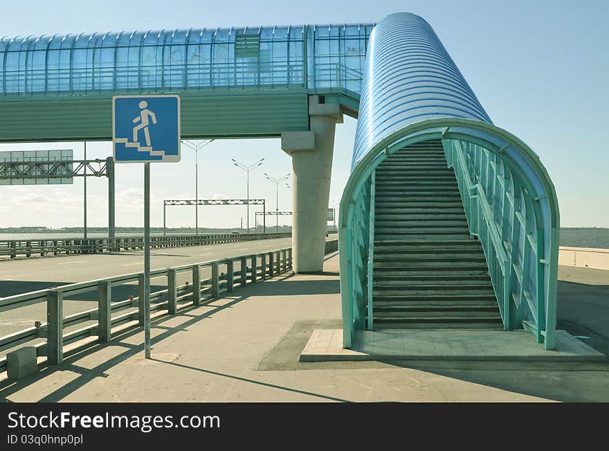 About a dark blue elevated pedestrian crossing