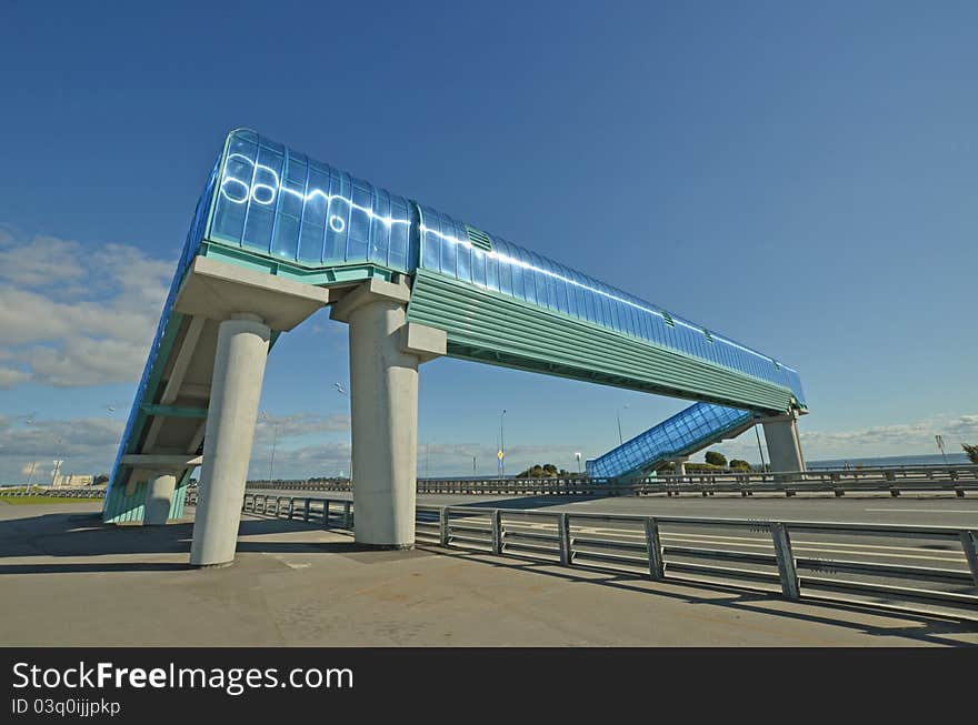 About a dark blue elevated pedestrian crossing