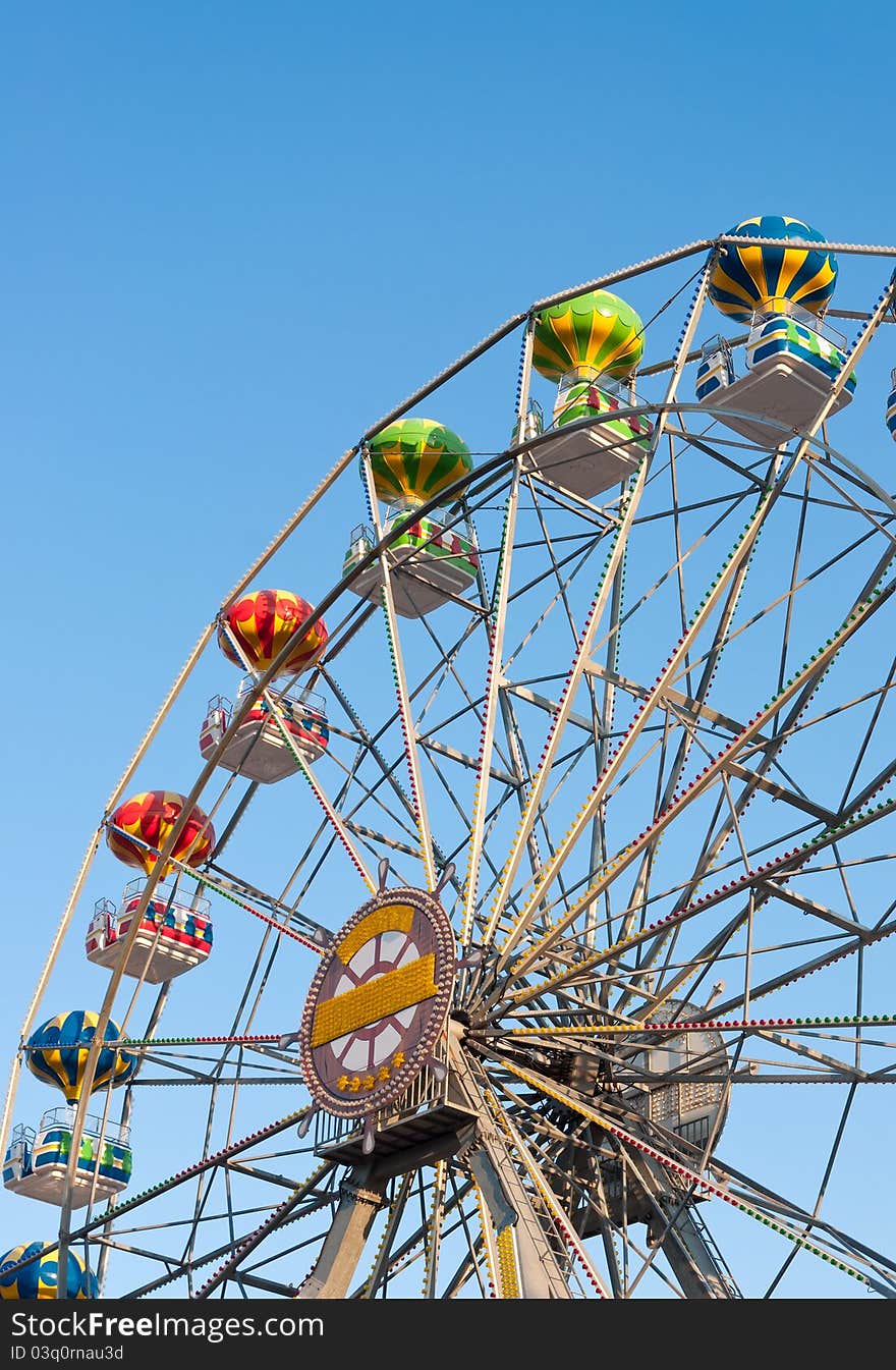 Ferris wheel on background sky.