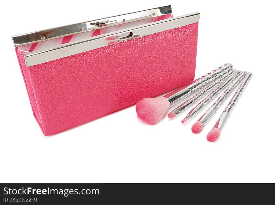 Pink handbag and cosmetic brushes