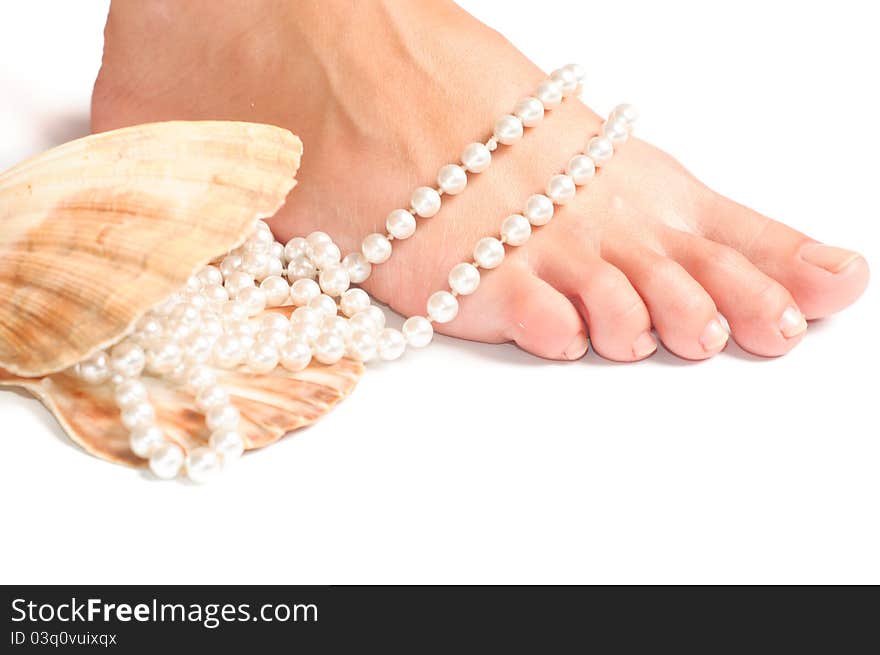 Feet and seashell on a white background