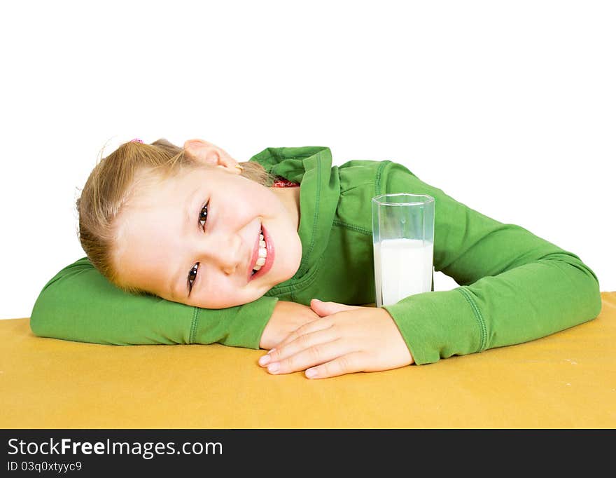 Happy little girl with a glass of milk, isolated over white