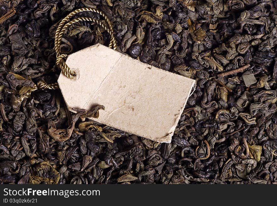 Macro photo of green tea leaves and paper label