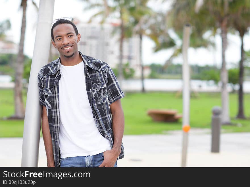 Image of a casually dressed black model smiling. Image of a casually dressed black model smiling