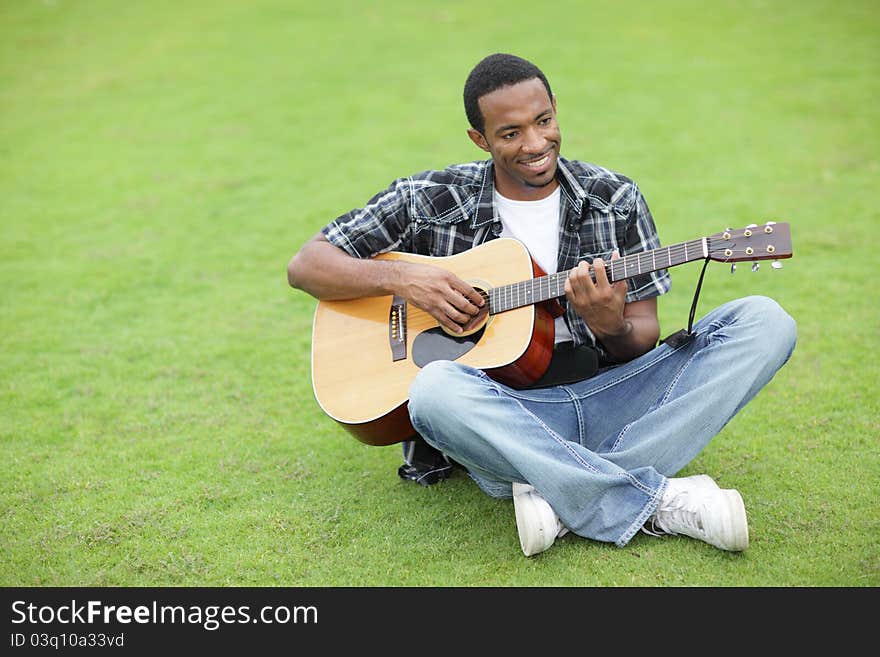 Man Playing Guitar In The Park