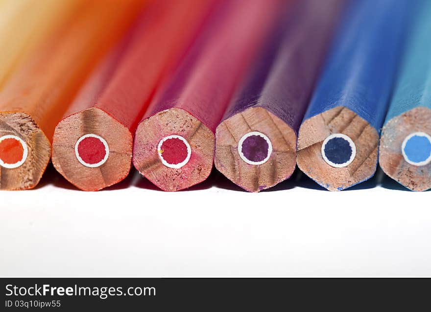 Manycolored pencils on the white background. Space for your text. Manycolored pencils on the white background. Space for your text