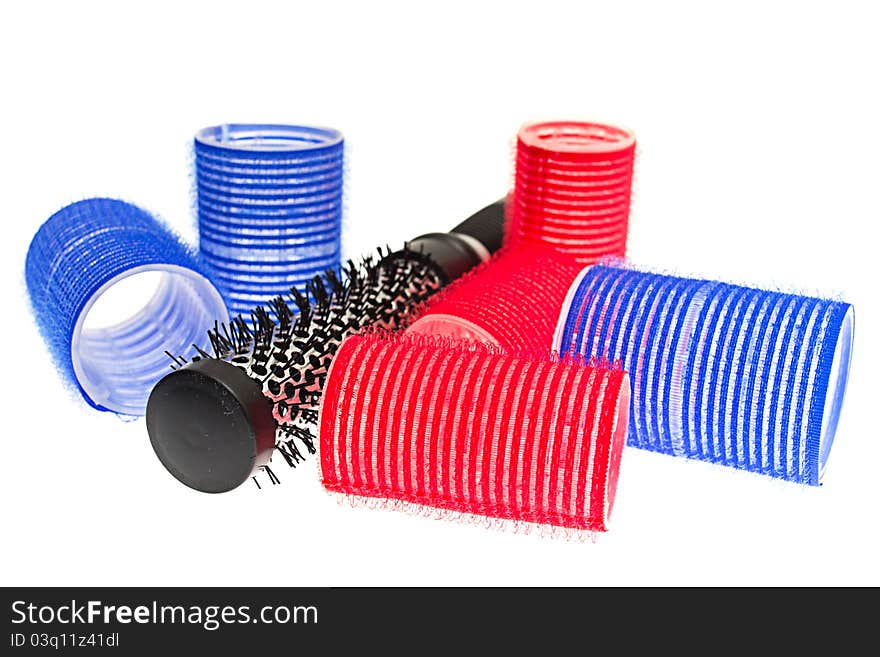 Curlers with hairbrush on white