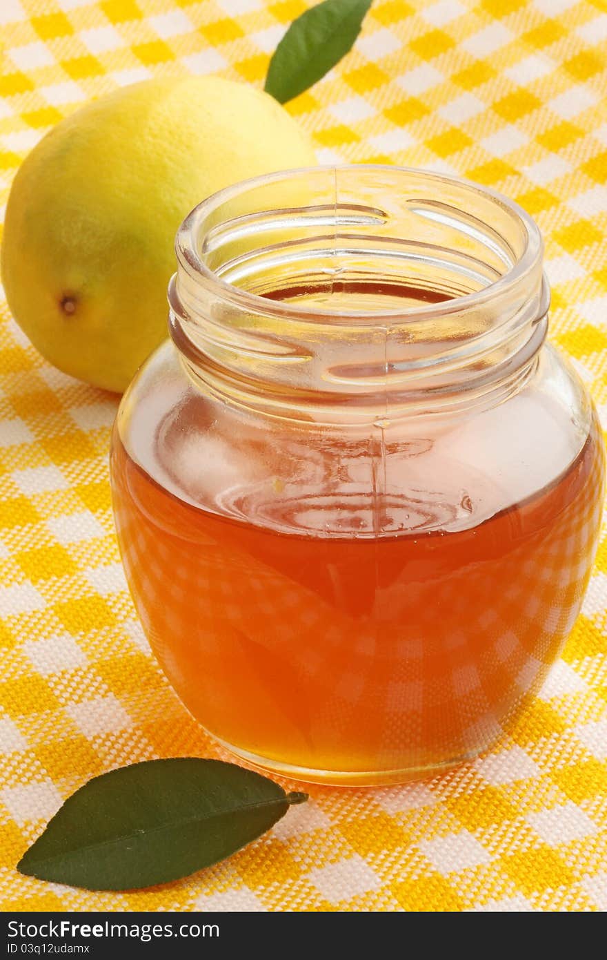 Jar of fresh honey with the lemon. Jar of fresh honey with the lemon