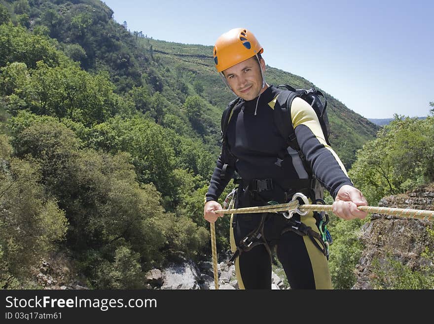 Intructor of canyoning to hold the rope. Intructor of canyoning to hold the rope