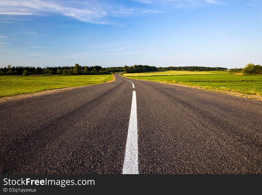 The small asphalted road passing in countryside. The small asphalted road passing in countryside