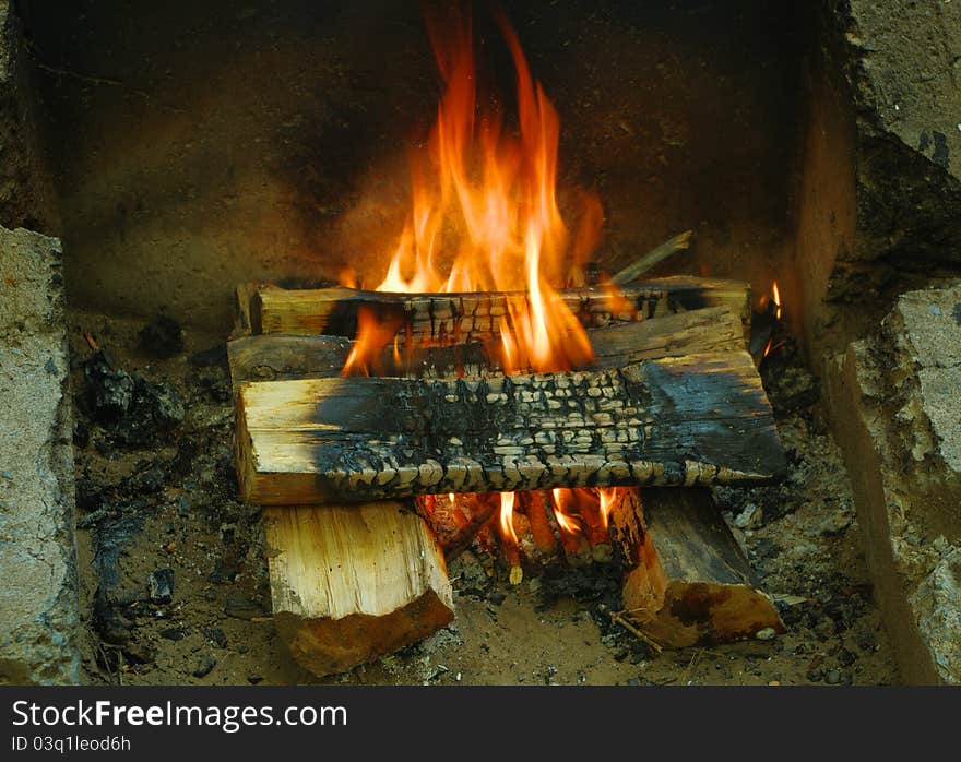 Burning logs in a campfire.