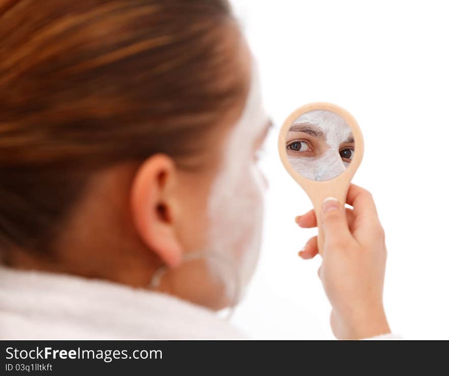 Young woman looking at the beauty mirror. Young woman looking at the beauty mirror