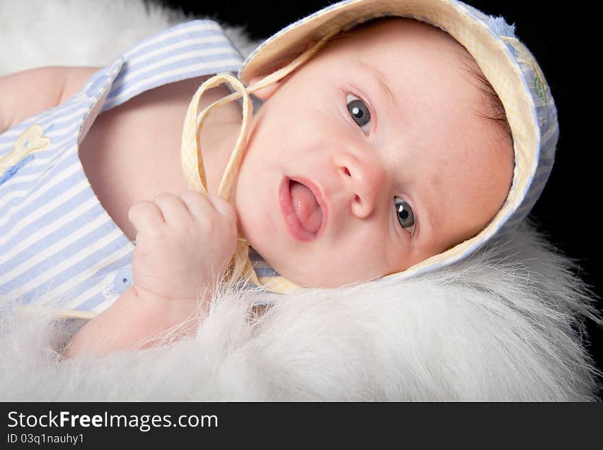 Curious baby boy in hat with mouth open