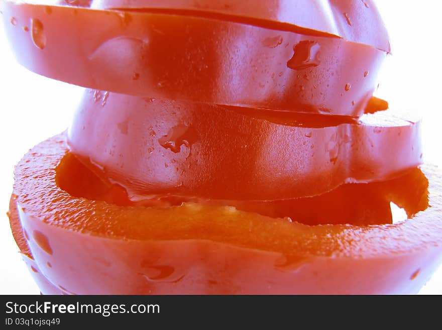 Sliced red pepper in detail with water drops