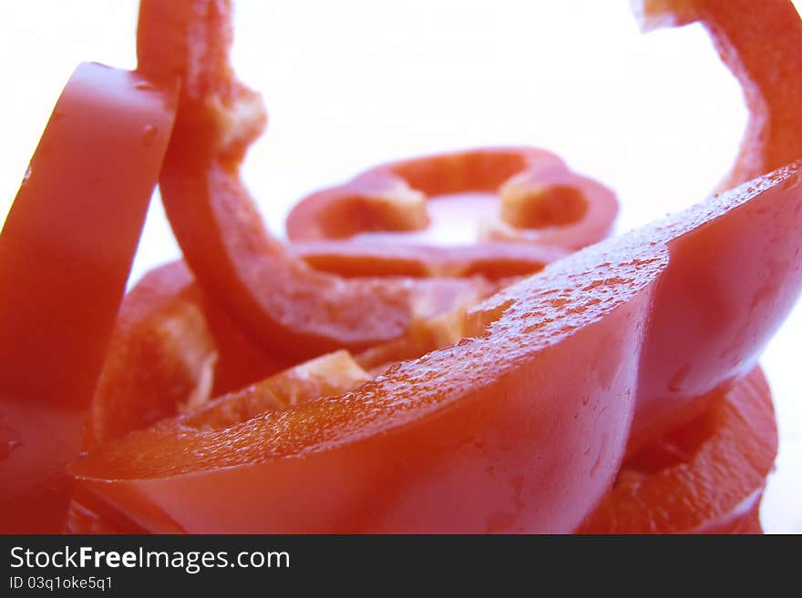 Sliced red pepper in detail on white background