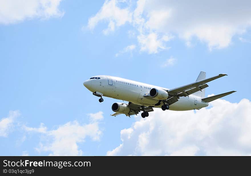 Landing passenger airliner in blue sky. Landing passenger airliner in blue sky