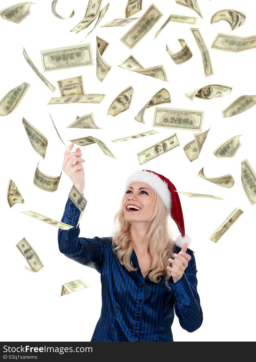 Smiling christmas girl catching falling dollars banknotes wearing Santa hat. Isolated on white background. Smiling christmas girl catching falling dollars banknotes wearing Santa hat. Isolated on white background.