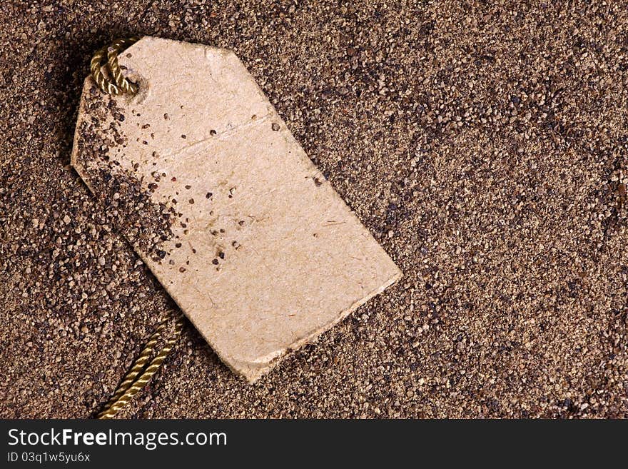 Closeup of ground black pepper with a label on a shoestring. Closeup of ground black pepper with a label on a shoestring