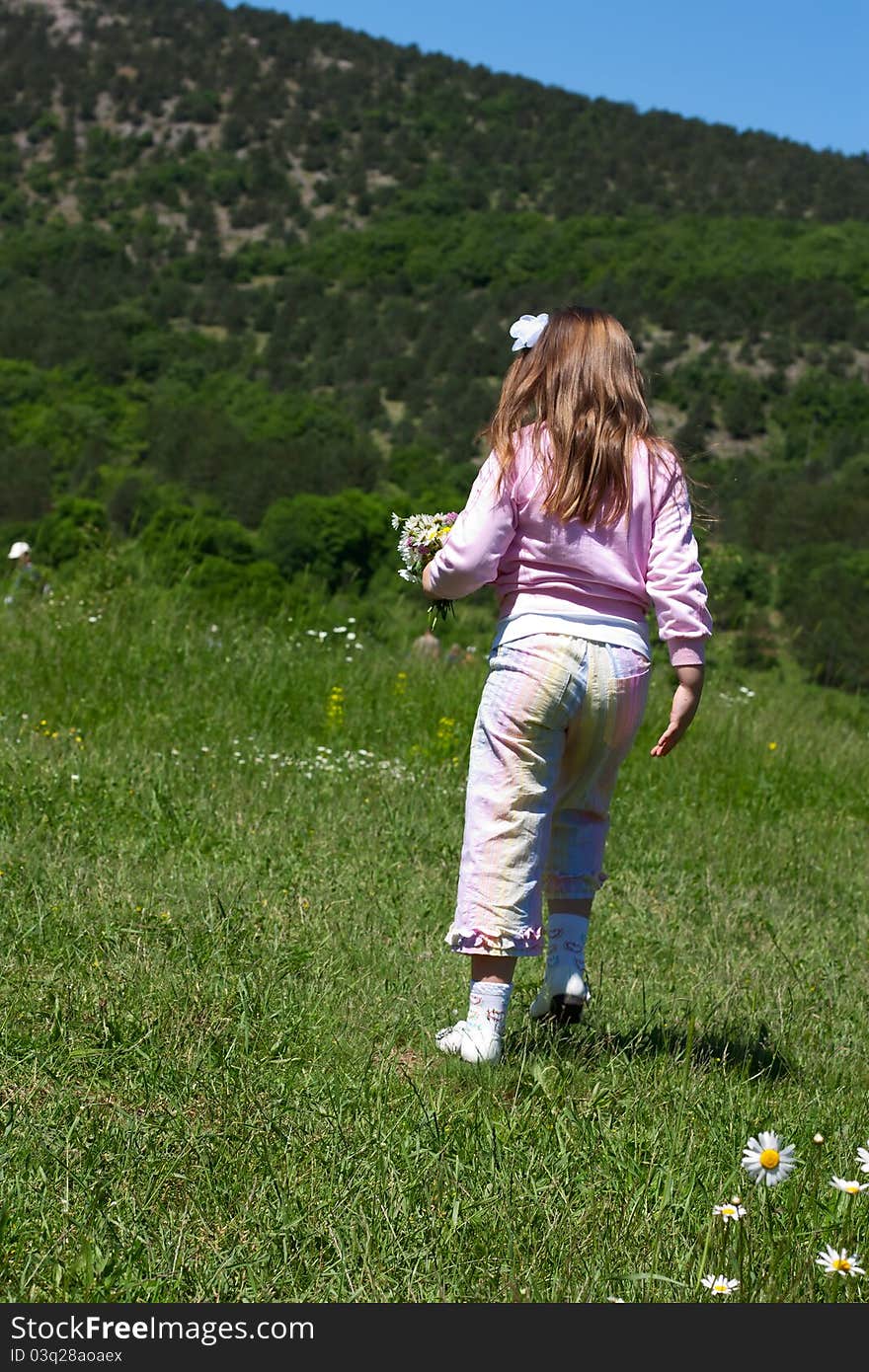 Little girl running on a  meadow. Little girl running on a  meadow